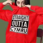 Person wearing a red hoodie with 'Straight Outta Cymru' text on a green background