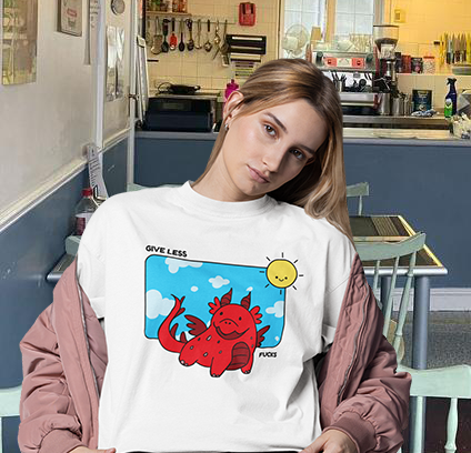 Model wearing GLF T-Shirt with red dragon design and 'Give Less' slogan, featuring a sunny background.