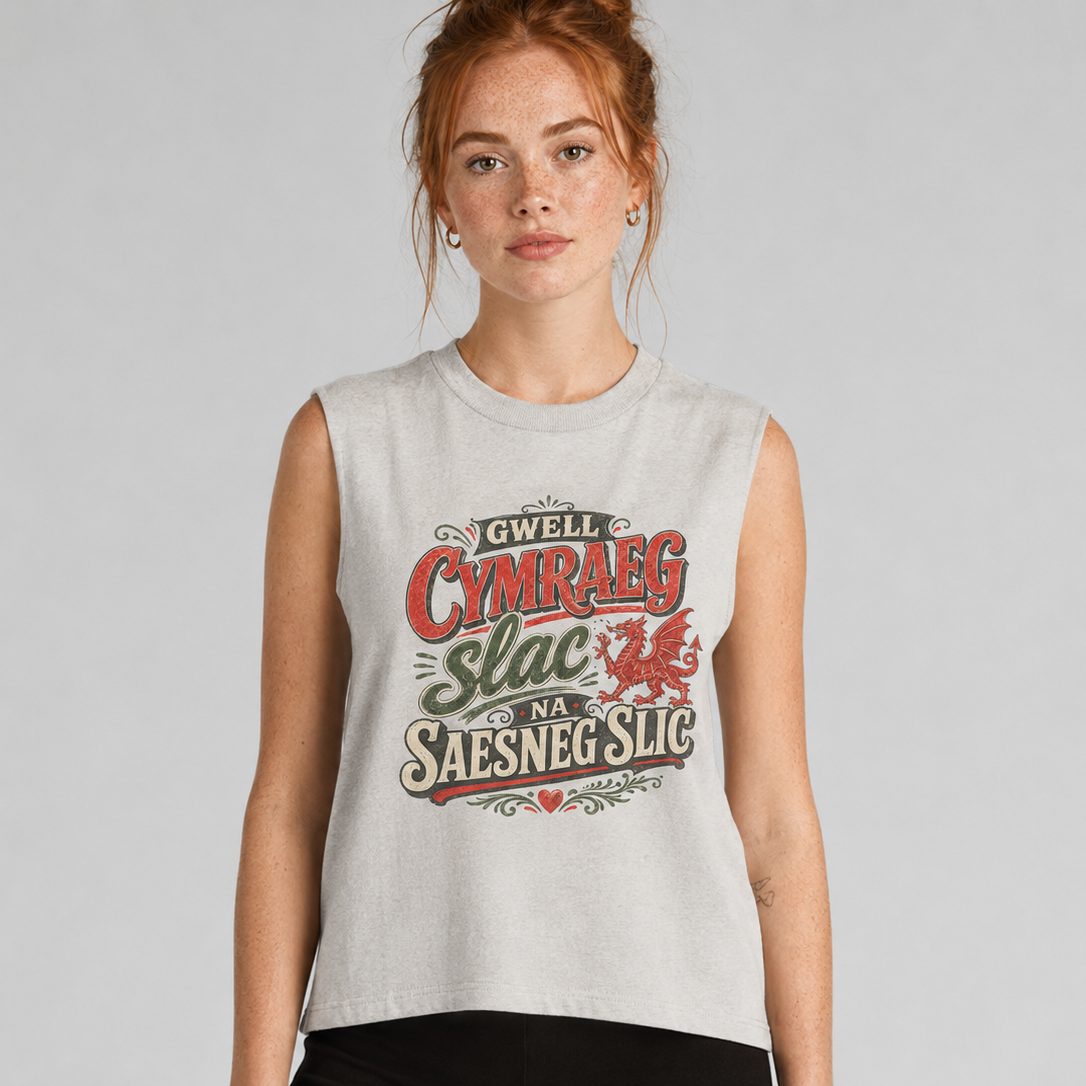 Woman wearing a sleeveless shirt with Welsh text and a dragon design on a plain background