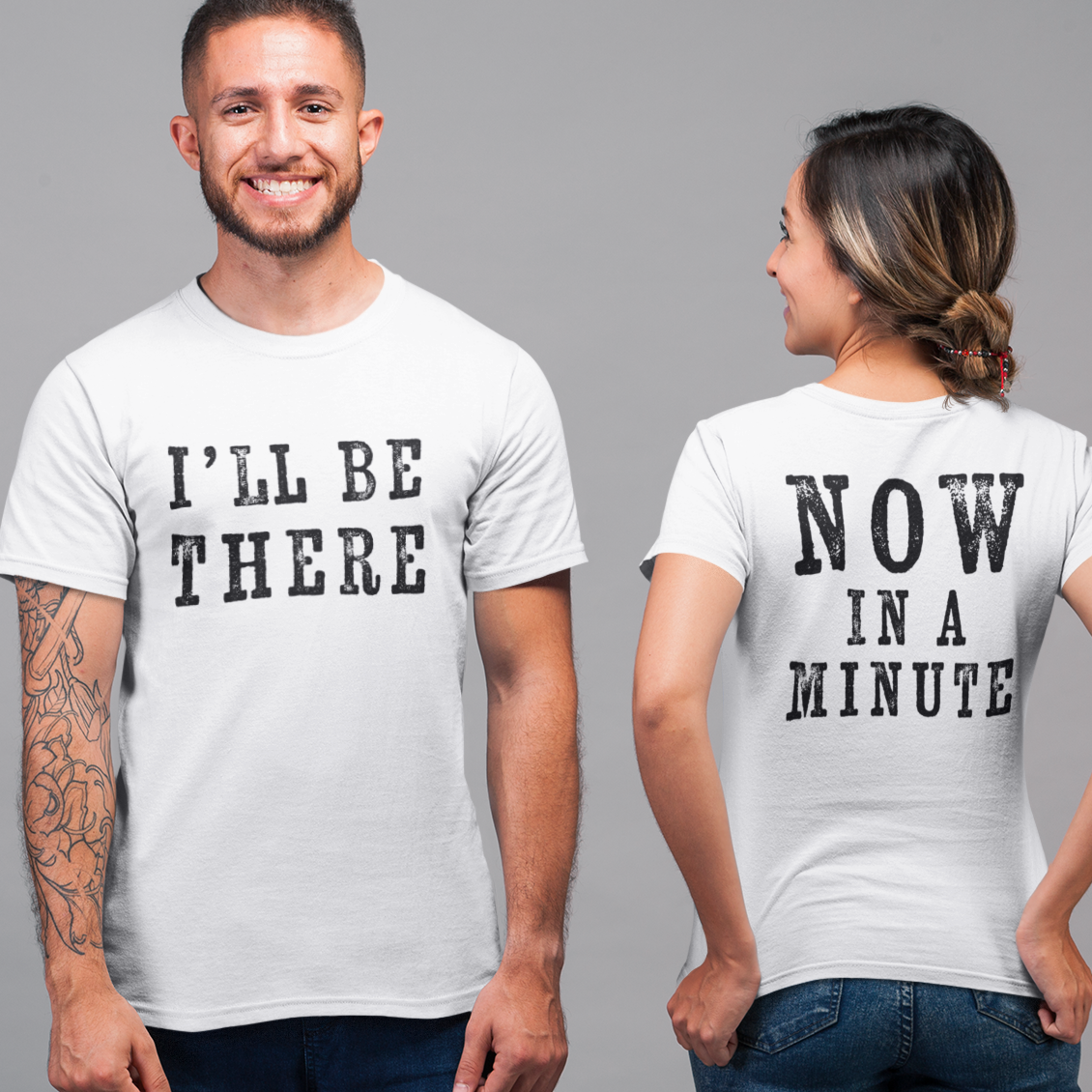 Man and woman wearing matching white t-shirts with text on a gray background