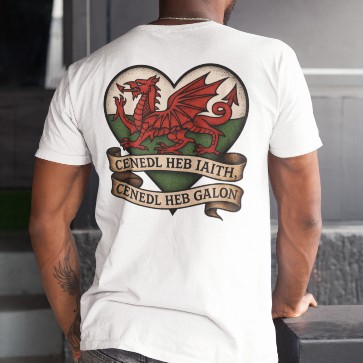 Person wearing a white t-shirt with a red dragon design on the back, standing in an indoor setting.