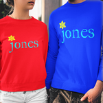 Two models wearing matching crewneck sweatshirts with 'jones' printed in teal with a yellow flower accent, one in red and one in blue, paired with white denim shorts and distressed black jeans respectively.
