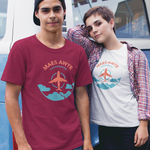 Two people wearing t-shirts with 'MAES AWYR CAERNARFON' design in front of a blue van.