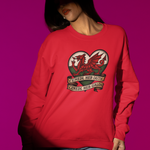 Person wearing a red sweatshirt with a dragon design on a pink background
