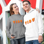 A man and a woman standing outdoors in front of a modern white and red geometric building. The woman wears a gray hoodie with orange 'TIDY' lettering, and the man wears a white hoodie with orange 'TIDY' lettering.