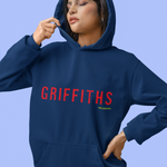 Person wearing a navy hoodie with 'GRIFFITHS' printed in red on a light blue background