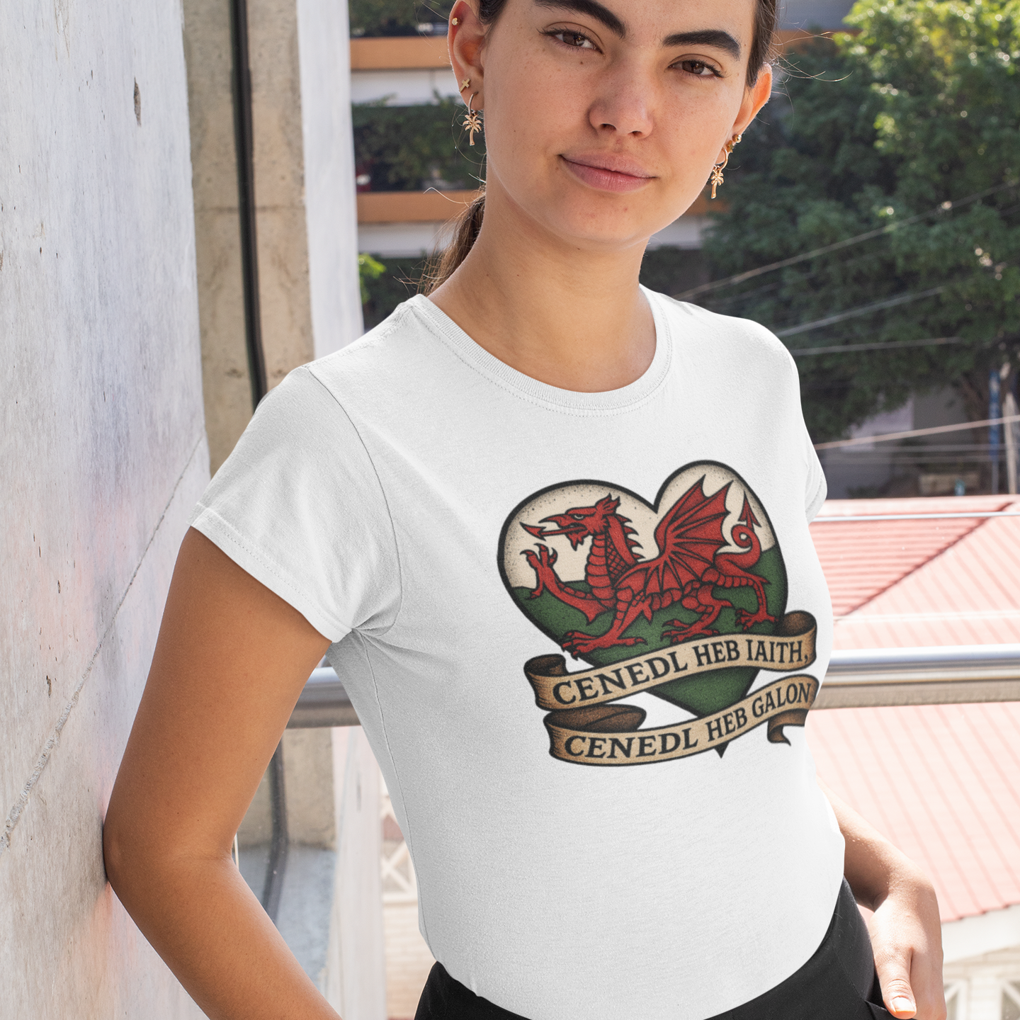 Woman wearing a white t-shirt with a dragon design and text outdoors.