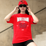 Person wearing a red 'Wreccsam' t-shirt and cap outdoors.