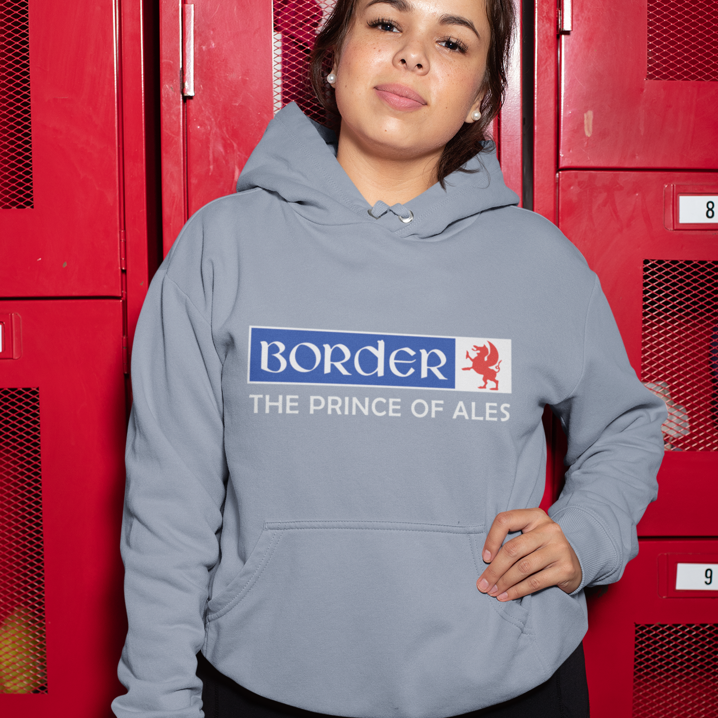 Person wearing a hoodie with 'Border' branding in front of red lockers