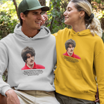 Two people wearing hoodies with printed images in a forest setting