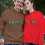 A man and a woman standing together on an outdoor paved walkway with trees in the background. The man wears a brown hoodie with green 'PARRY' lettering, and the woman wears a bright red hoodie with green 'PARRY' lettering.
