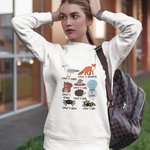 Woman wearing a white sweatshirt with graphic designs outdoors