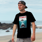 Person wearing a black t-shirt with a graphic design on a beach
