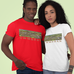 Two models wearing short-sleeve graphic t-shirts against a solid pale green background. The model on the left wears a red t-shirt and the model on the right wears a white t-shirt, both featuring a rectangular landscape graphic with the text 'CWMBRAN' printed across the chest.
