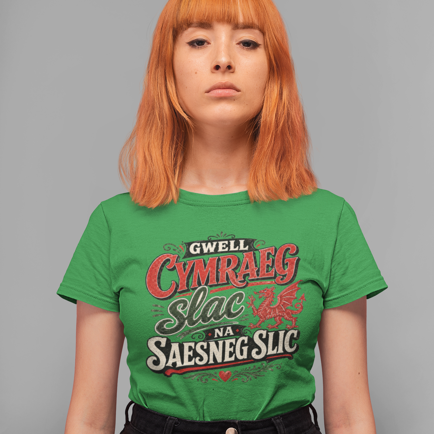 Person wearing a green t-shirt with Welsh language text on a gray background