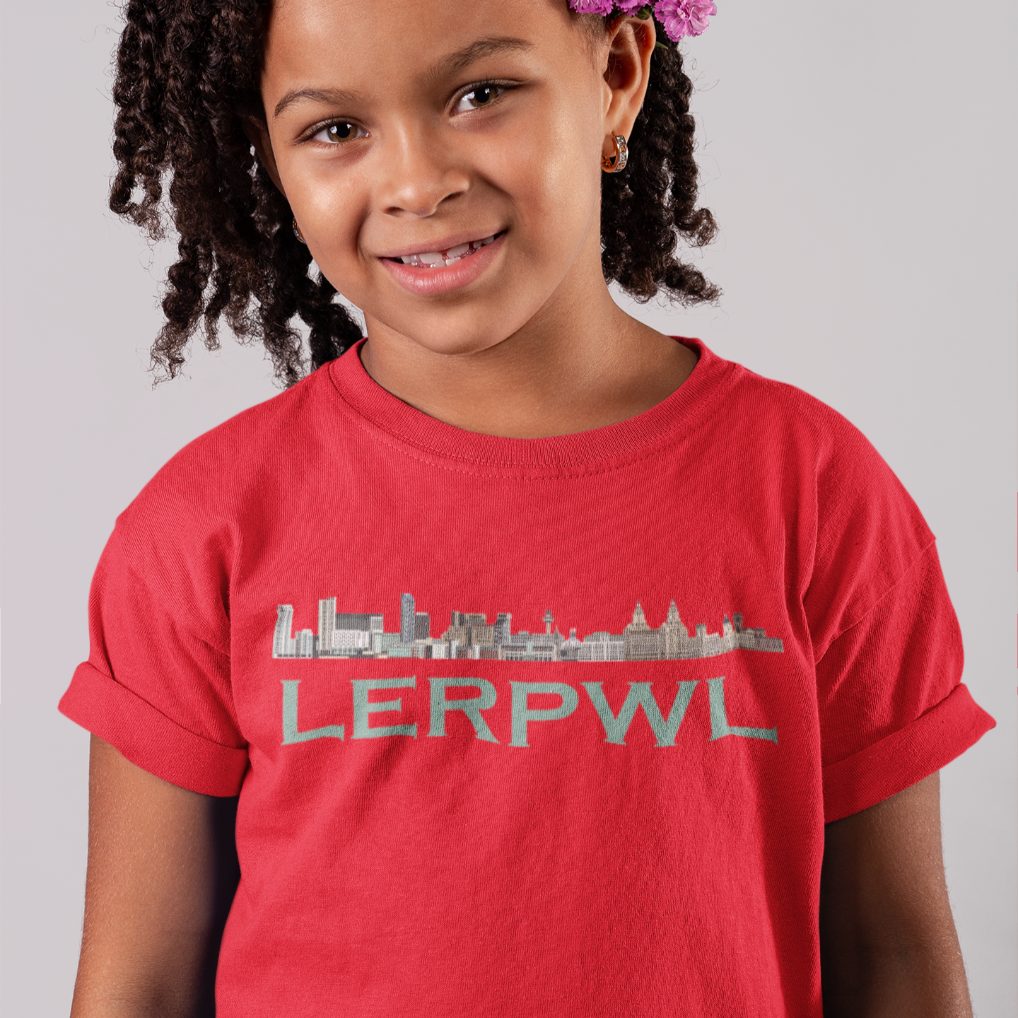 Young girl wearing a red t-shirt with 'LERPWL' printed on it against a gray background
