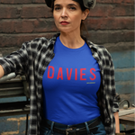Person wearing a blue 'DAVIES' t-shirt in a workshop setting